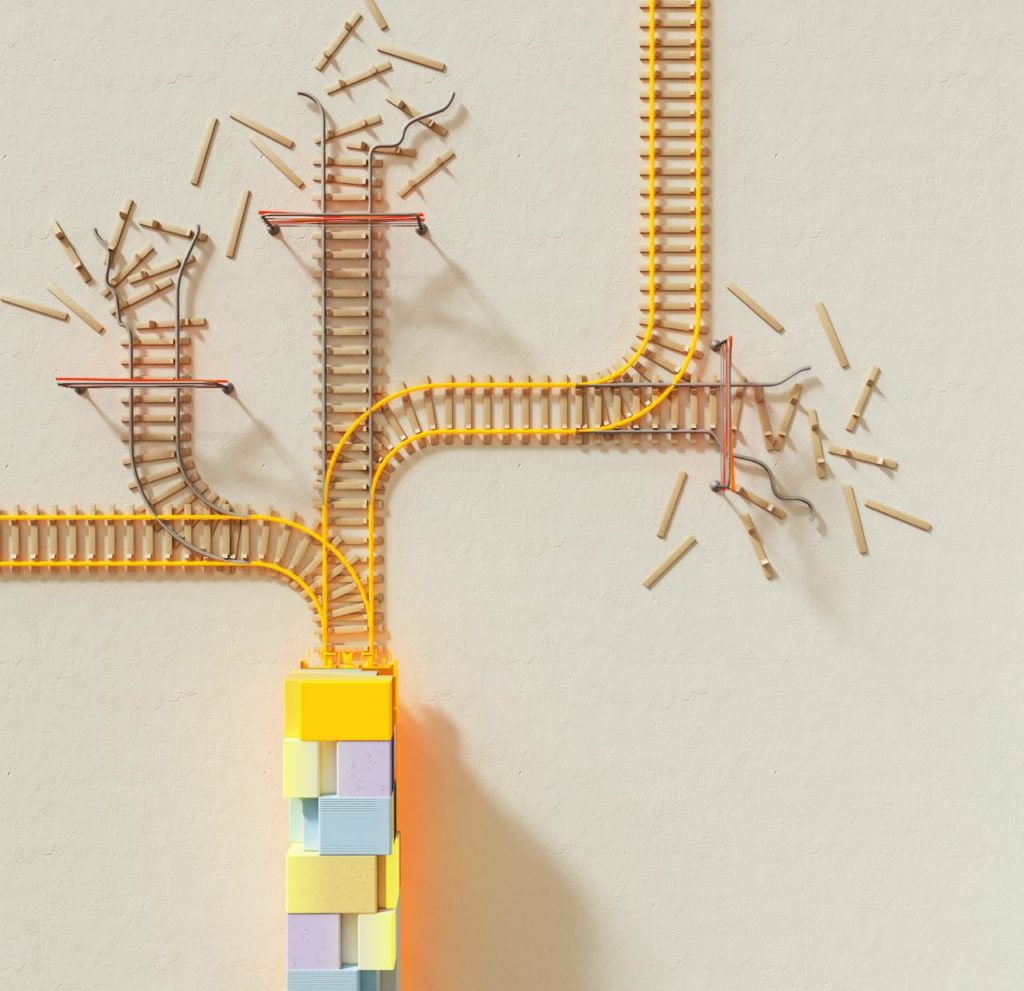 pexels-photo-17485633 Creative illustration of train tracks on wooden blocks, depicting decision making concepts.